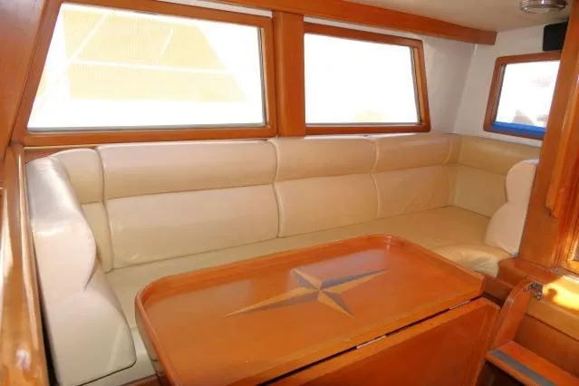 Slide: The Image of Luxurious interior of 2002 Tayana 460 Vancouver Pilothouse with beige seating and wooden table. - 8