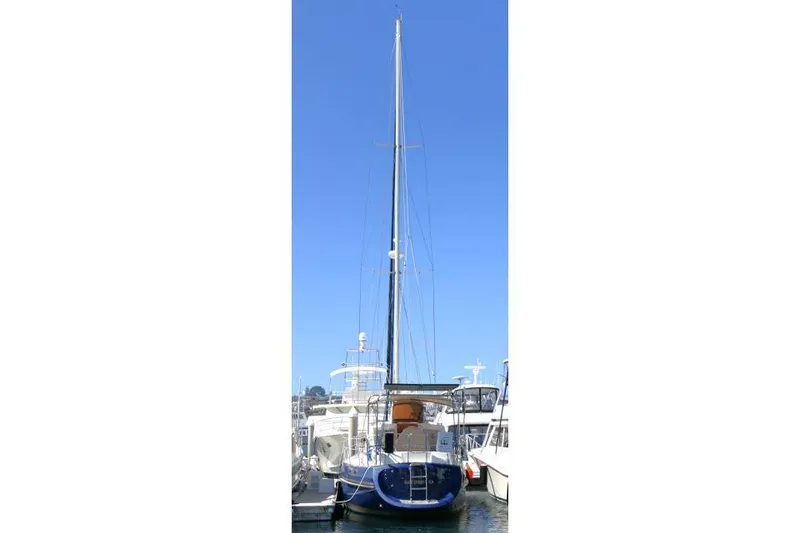 Slide: The Image of 2002 Tayana 460 Vancouver Pilothouse sailboat docked in marina under clear blue sky. - 82