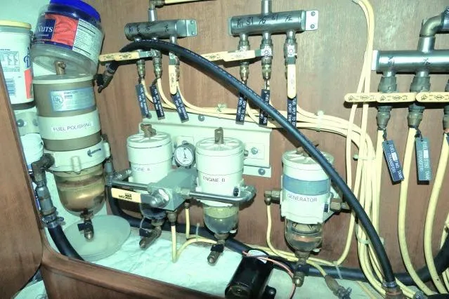 Slide: The Image of Fuel system components in a 2002 Tayana 460 Vancouver Pilothouse yacht engine room. - 97