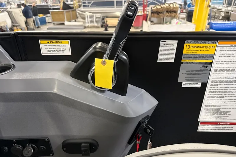 Slide: The Image of Control panel of 2026 Godfrey Sweetwater 22' Tritoon with capacity and caution labels. - 10