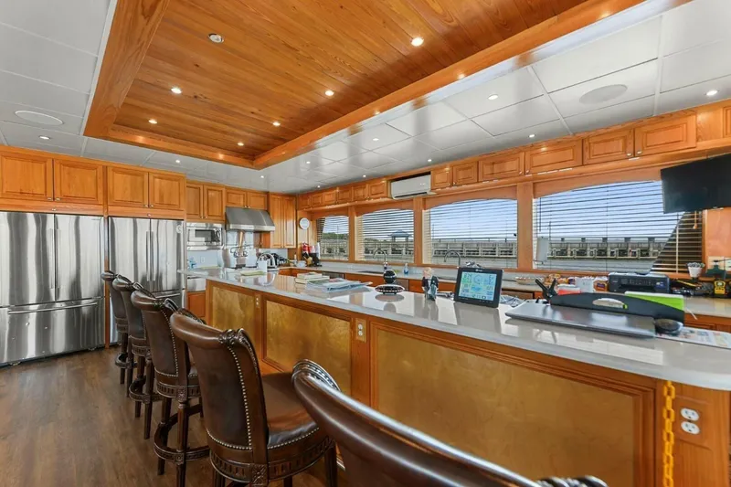 Slide: The Image of Luxurious kitchen interior of 2018 Avenger Custom Luxury Catamaran Coastal Cruiser with wooden accents. - 15