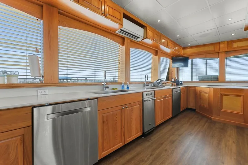 Slide: The Image of Luxurious kitchen interior of 2018 Avenger Custom Catamaran with wood cabinetry and modern appliances. - 19