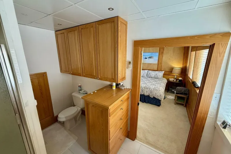 Slide: The Image of Luxurious catamaran interior with wooden cabinetry, bathroom, and cozy bedroom, 2018 Avenger model. - 25