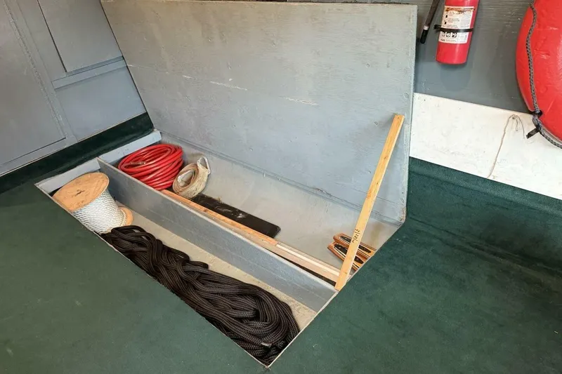 Slide: The Image of Storage compartment on 2018 Avenger Custom Luxury Catamaran, featuring ropes and safety equipment. - 37