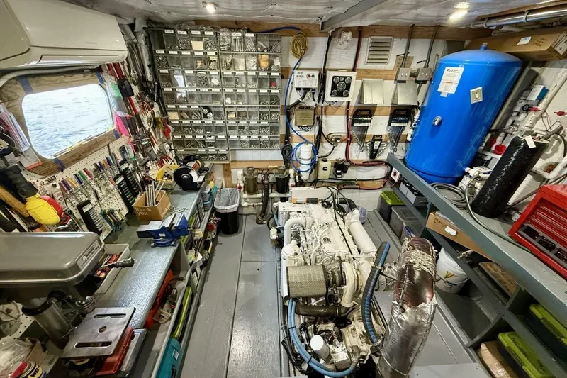 Slide: The Image of Engine room of 2018 Avenger Custom Luxury Catamaran Coastal Cruiser, featuring organized tools and equipment. - 40