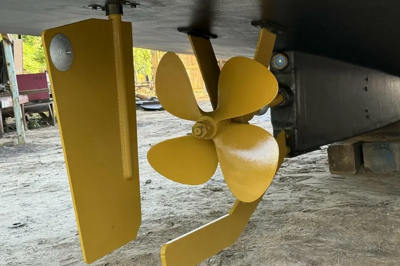 Slide: The Image of Yellow propeller and rudder of 2018 Avenger Custom Luxury Catamaran Coastal Cruiser. - 43