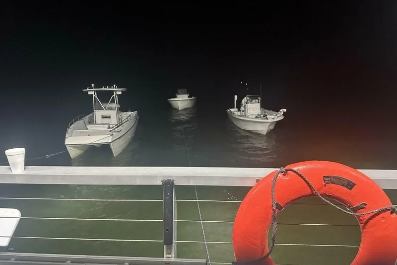 Slide: The Image of Boats moored at night near a 2018 Avenger Custom Luxury Catamaran Coastal Cruiser. - 6