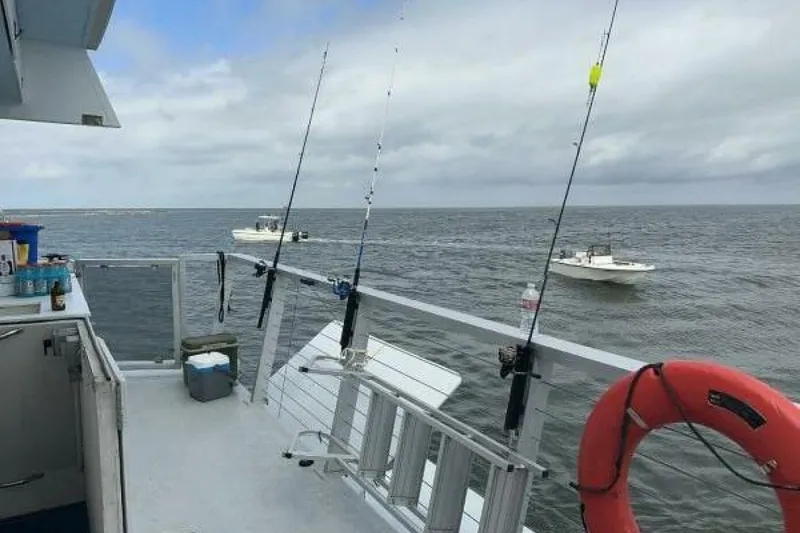 Slide: The Image of 2018 Avenger Custom Luxury Catamaran with fishing rods and ocean view. - 7