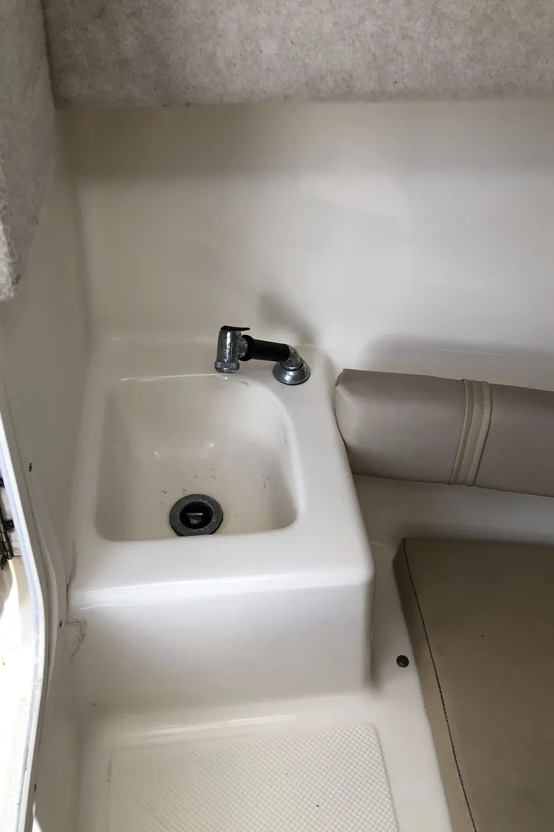 Slide: The Image of 2008 Key West 2300 Walkaround boat interior with sink and seating area. - 17