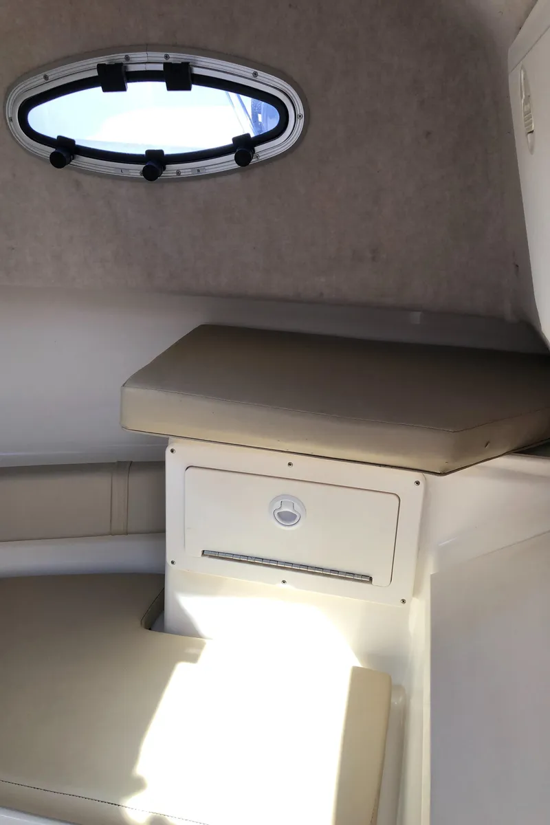Slide: The Image of Interior cabin of 2008 Key West 2300 Walkaround boat with seating and porthole. - 18
