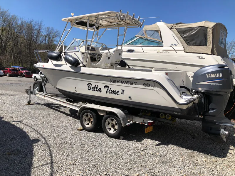 Slide: The Image of 2008 Key West 2300 Walkaround boat on trailer, named "Bella Time II," with Yamaha outboard motor. - 2