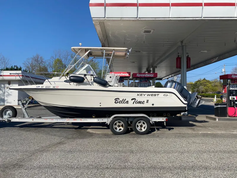 Slide: The Image of 2008 Key West 2300 Walkaround boat on trailer at gas station. - 4