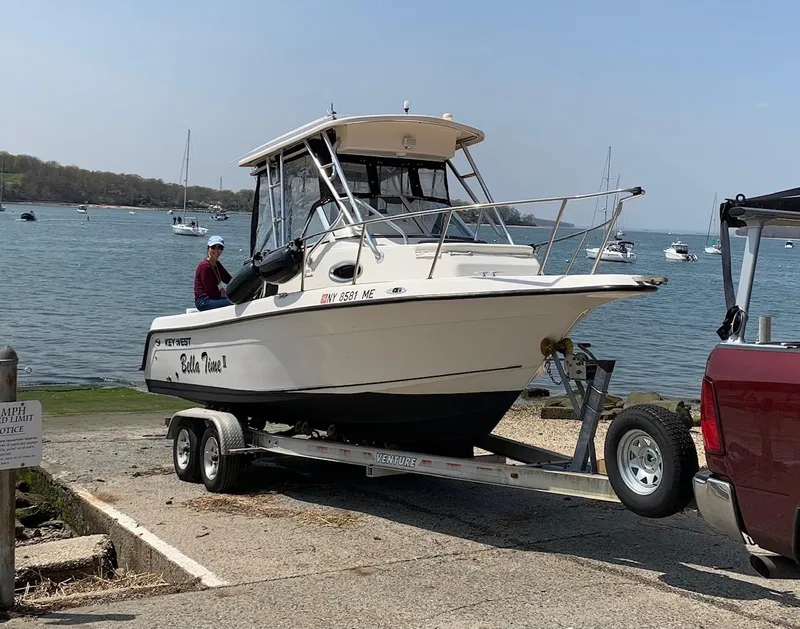 Slide: The Image of 2008 Key West 2300 Walkaround boat on trailer by the water, ready for launch. - 5