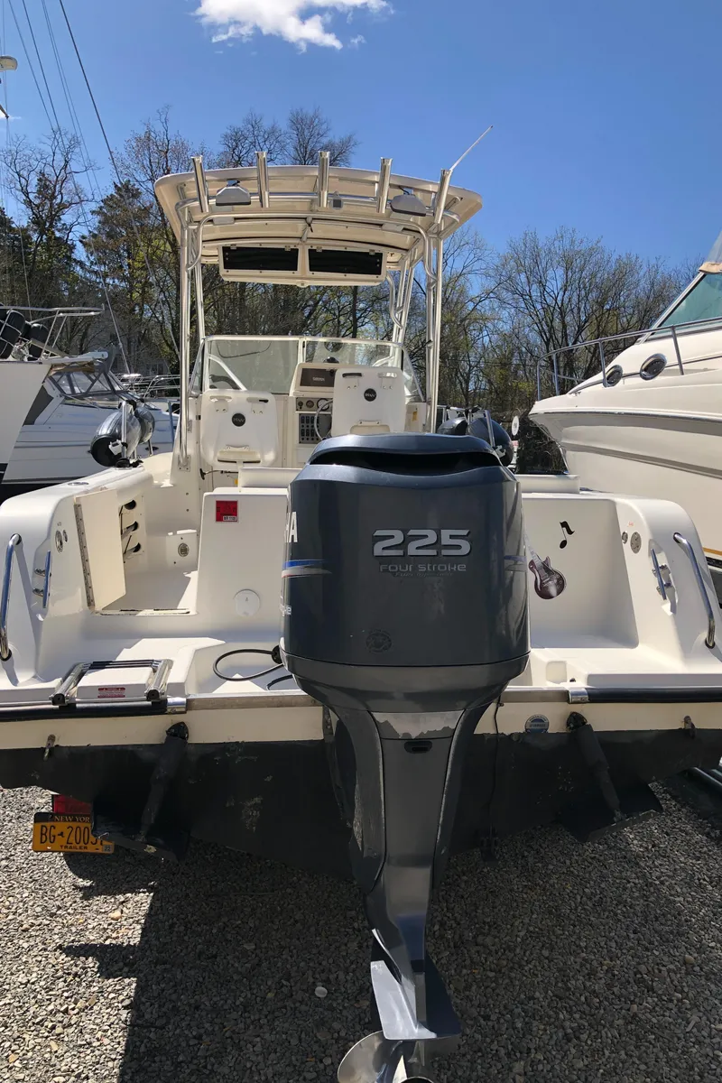 Slide: The Image of 2008 Key West 2300 Walkaround boat with Yamaha 225 engine, docked outdoors. - 7