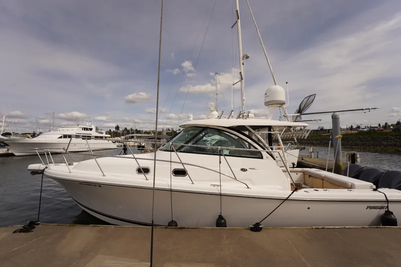 The Image of 2015 Pursuit OS 385 Offshore boat docked at marina under cloudy sky. - 0
