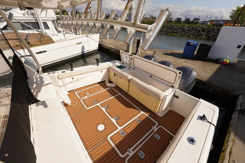 Slide: The Image of 2015 Pursuit OS 385 Offshore boat with teak deck, docked at marina. - 13