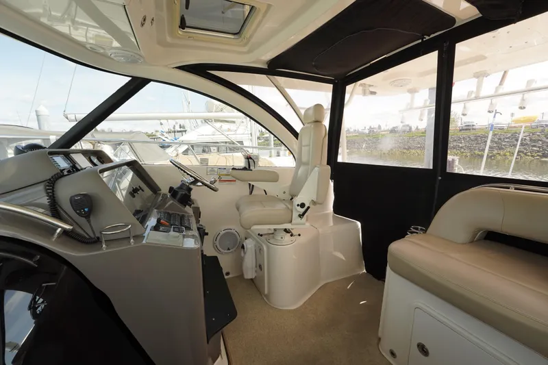 Slide: The Image of 2015 Pursuit OS 385 Offshore boat interior with helm, seating, and navigation equipment. - 21