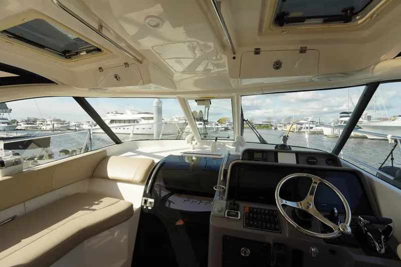 Slide: The Image of Interior view of 2015 Pursuit OS 385 Offshore boat, featuring helm and seating area. - 25