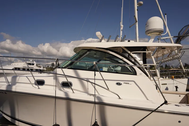 Slide: The Image of 2015 Pursuit OS 385 Offshore boat docked under a clear blue sky. - 3