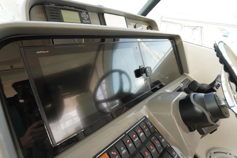 Slide: The Image of 2015 Pursuit OS 385 Offshore helm with GPS display and control panel. - 31