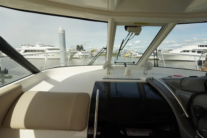Slide: The Image of Interior view of 2015 Pursuit OS 385 Offshore boat docked at marina. - 33