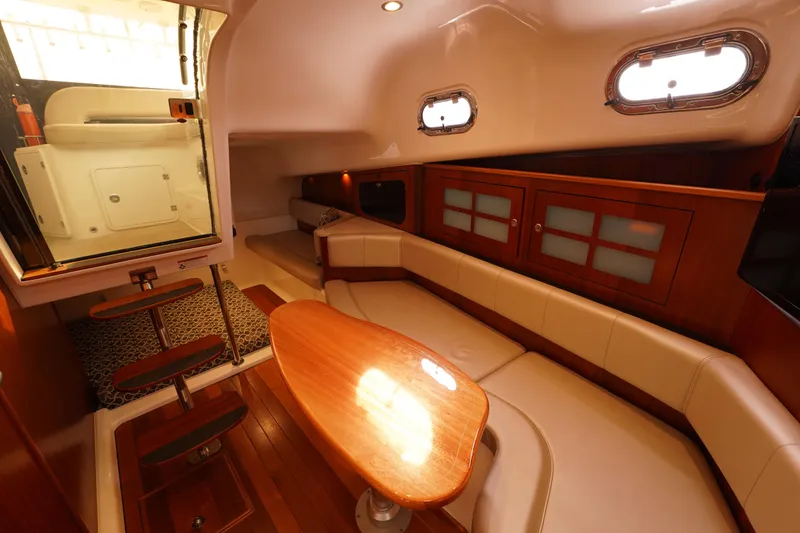 Slide: The Image of Luxurious interior of 2015 Pursuit OS 385 Offshore boat with elegant seating and wooden finishes. - 38