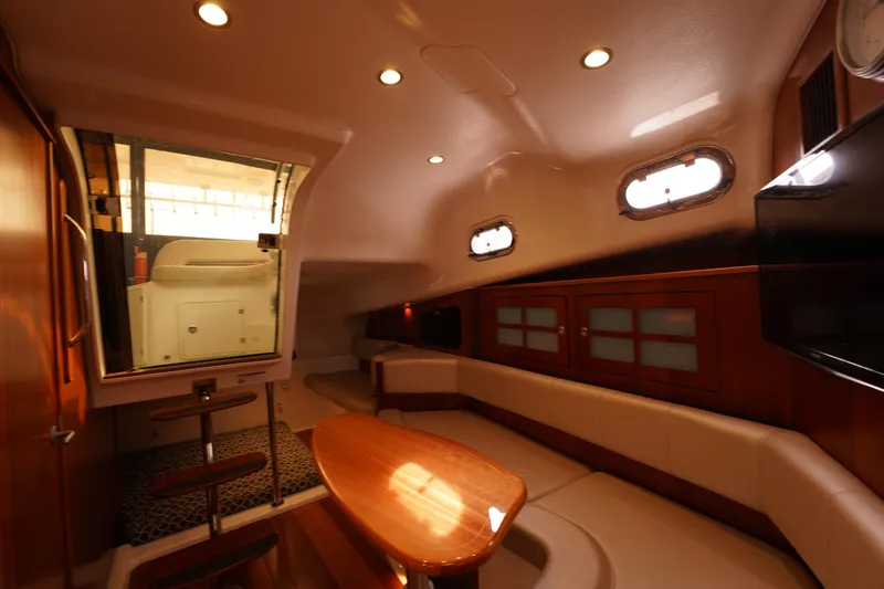 Slide: The Image of Interior of 2015 Pursuit OS 385 Offshore yacht, featuring elegant seating and wooden finishes. - 39