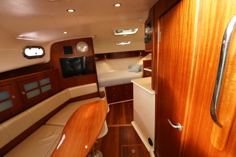 Slide: The Image of Luxurious interior of 2015 Pursuit OS 385 Offshore boat with wood finish and cozy seating. - 40