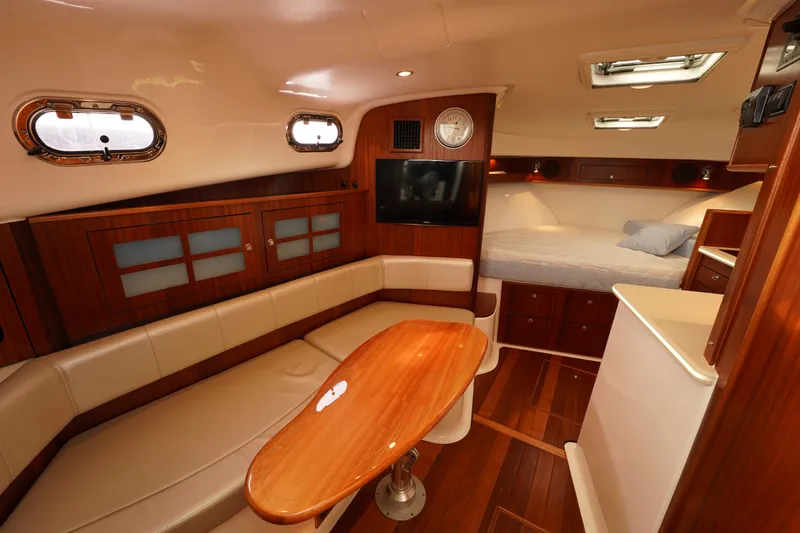 Slide: The Image of Luxurious interior of 2015 Pursuit OS 385 Offshore yacht with wood finishes and cozy seating. - 41