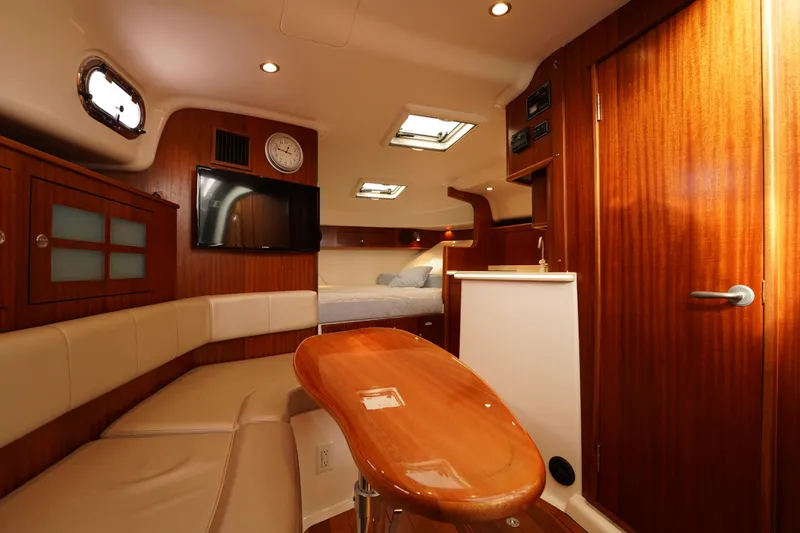 Slide: The Image of Luxurious interior of 2015 Pursuit OS 385 Offshore boat with wood finishes and seating area. - 42
