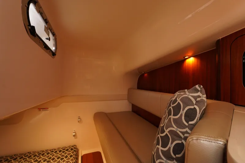 Slide: The Image of 2015 Pursuit OS 385 Offshore cabin interior with cozy seating and ambient lighting. - 45