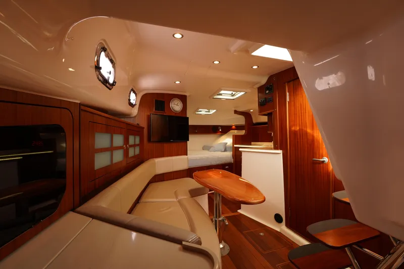 Slide: The Image of Luxurious interior of 2015 Pursuit OS 385 Offshore yacht with wood finishes and cozy seating. - 46