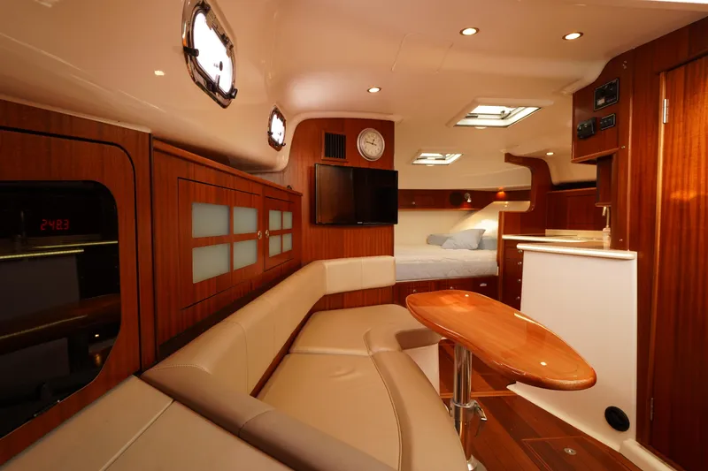 Slide: The Image of Luxurious interior of 2015 Pursuit OS 385 Offshore yacht with wood finishes and modern amenities. - 47