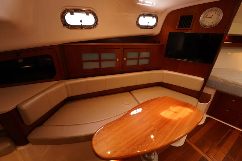 Slide: The Image of Luxurious interior of 2015 Pursuit OS 385 Offshore yacht with cozy seating and wooden table. - 48