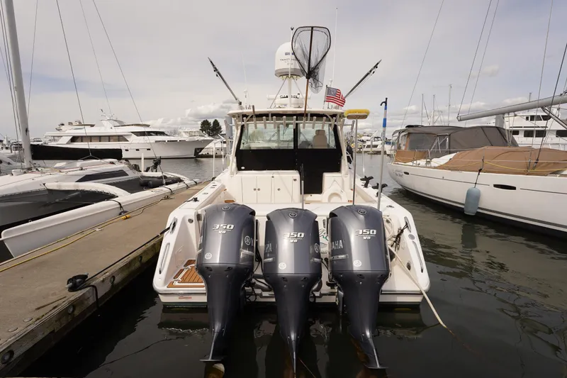 Slide: The Image of 2015 Pursuit OS 385 Offshore boat docked with triple Yamaha 350 engines. - 5