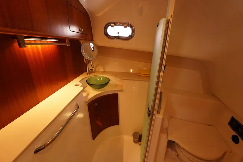 Slide: The Image of 2015 Pursuit OS 385 Offshore yacht bathroom with wood cabinetry and modern fixtures. - 55
