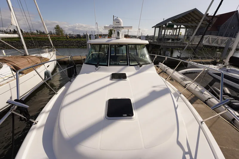 Slide: The Image of 2015 Pursuit OS 385 Offshore boat docked at marina, sunny day. - 56
