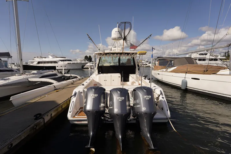 Slide: The Image of 2015 Pursuit OS 385 Offshore boat docked with triple Yamaha 350 engines. - 6