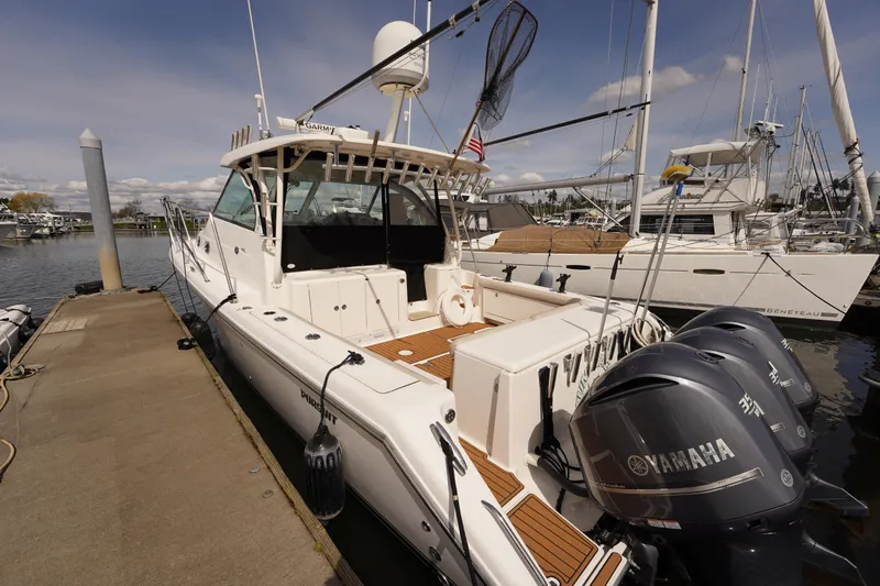 Slide: The Image of 2015 Pursuit OS 385 Offshore boat docked with Yamaha engines, ready for adventure. - 8
