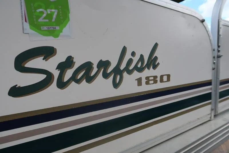 Slide: The Image of 1999 Starcraft Starfish 180 boat with registration sticker, featuring classic design and branding. - 6