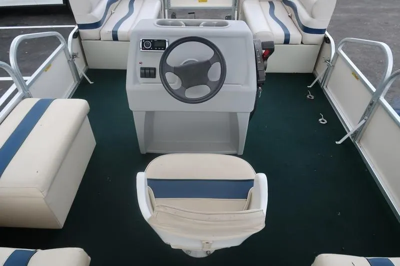 Slide: The Image of 1999 Starcraft Starfish 180 boat interior with steering wheel and seating arrangement. - 8