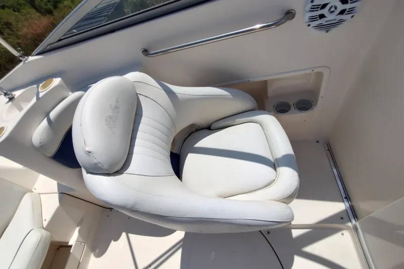 Slide: The Image of White captain's chair on 2005 Rinker 232 Captiva Cuddy boat interior. - 7