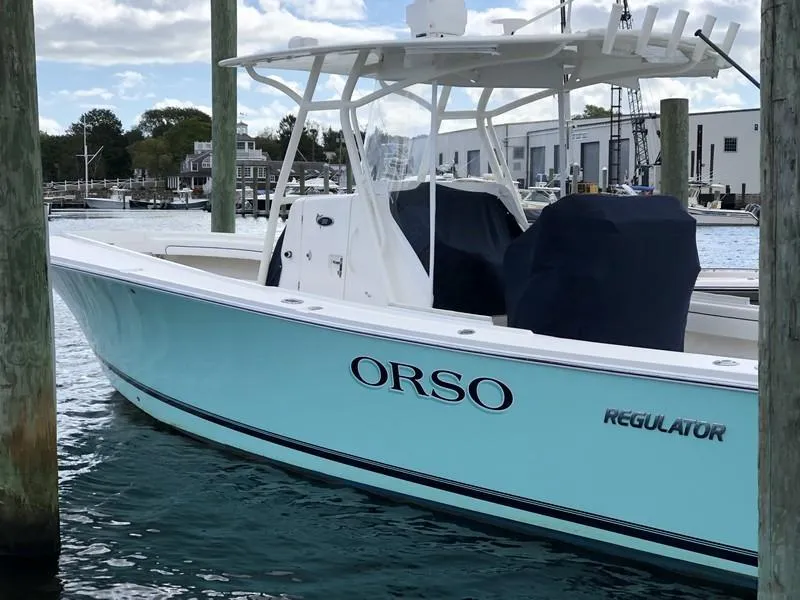 Slide: The Image of 2018 Regulator 31 boat named "ORSO" docked in a marina. - 12