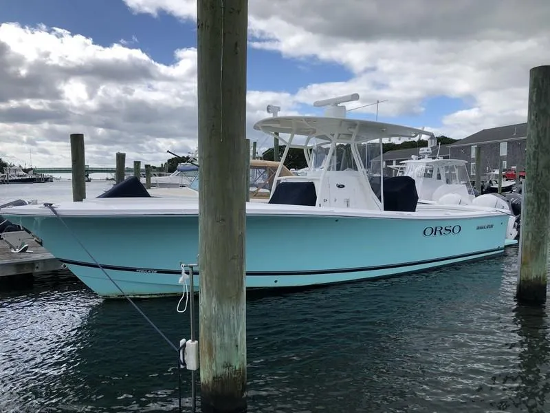 Slide: The Image of 2018 Regulator 31 boat docked in marina under cloudy sky. - 9