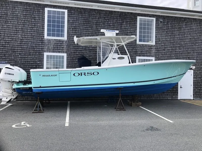 The Image of 2018 Regulator 31 boat on stands, parked near a building. - 0