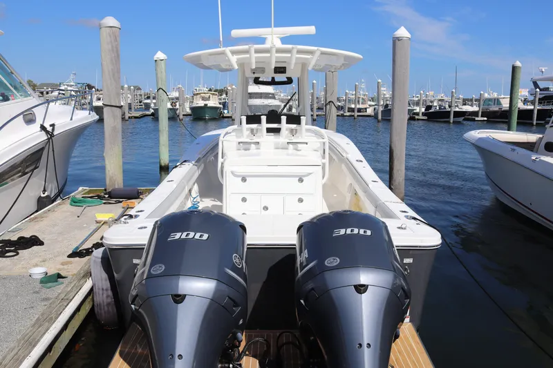 Slide: The Image of 2020 Regulator 31 boat with dual 300 horsepower engines docked at marina. - 1
