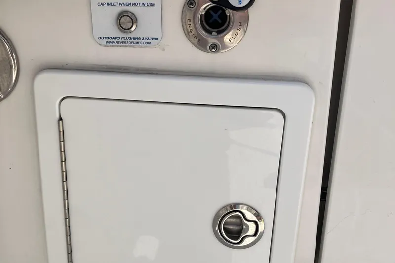 Slide: The Image of 2020 Regulator 31 boat outboard flushing system and storage compartment. - 13