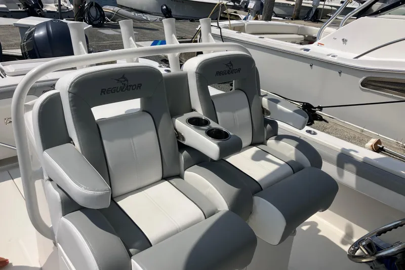 Slide: The Image of 2020 Regulator 31 boat seats with cup holders, docked in marina. - 14