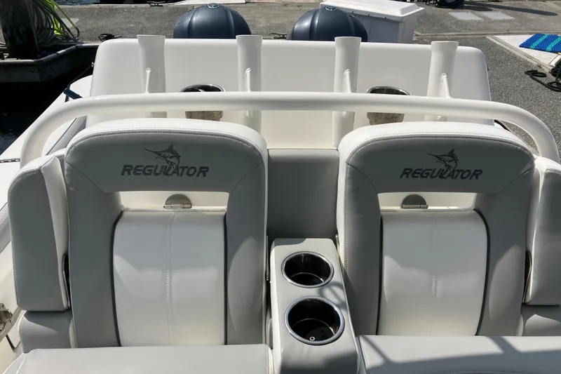 Slide: The Image of 2020 Regulator 31 boat seats with logo, featuring dual cup holders. - 15