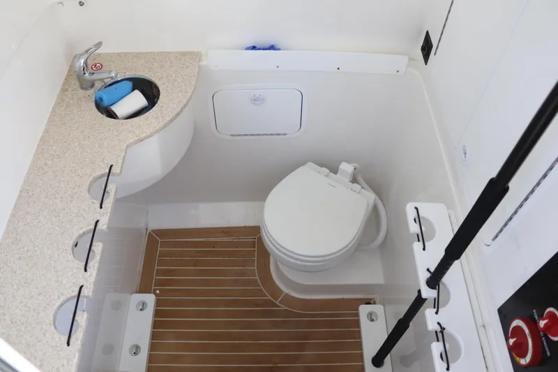 Slide: The Image of 2020 Regulator 31 boat bathroom with sink, toilet, and wooden floor. - 19